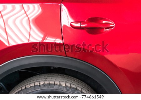 Car door handle red color for customers. Using wallpaper or background for transport and automotive image. wallpaper or background for transport and automotive image.