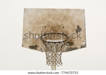 Outdoor basketball net covered in snow on cold winters day 