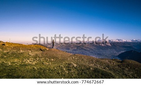 Photographer in travelling by beautiful landscape nature include grass field and mountain against sky in Luzern Switzerland