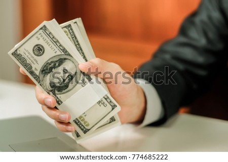 Man counting money,man in business clothes with dollars, Cash in hands. Profits, savings. Stack of dollars. Success, motivation, financial flows, wealth. Stack of dollars,dollars in hand.