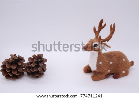 A deer figure with pinecones on the white background