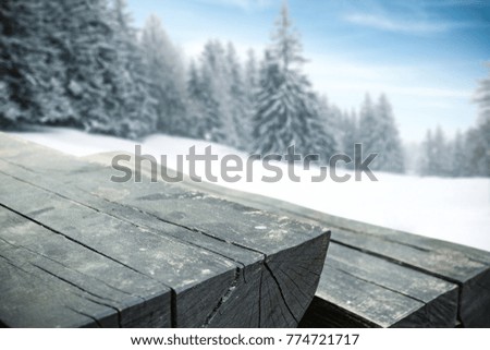 Old wooden retro table and winter landscape with trees of snow and frost. Photo with free space for your decoration. 