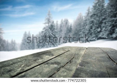 Old wooden retro table and winter landscape with trees of snow and frost. Photo with free space for your decoration. 