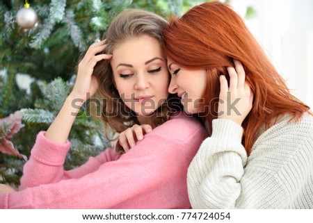 Young beautiful women near christmas trees. New year concept.