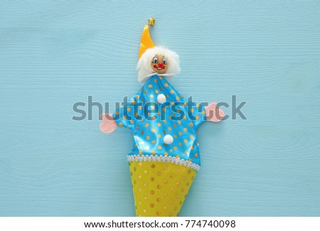 Purim celebration concept (jewish carnival holiday). Top view of clown noise maker toy