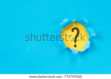 blue torn paper revealing question mark symbol on yellow paper. question mark background Royalty-Free Stock Photo #774749260