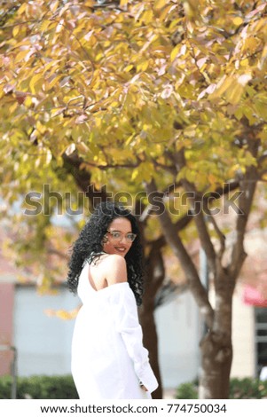 happy african american beautiful girl, looking back with hope and joyness, ethnicity, background autumn style bokeh
