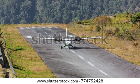 The aircraft on the runway of the Tenzing-Hillary airport Lukla - Nepal, Himalayas