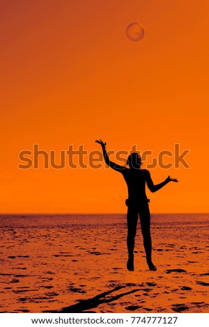 picture of a child with a ball on the beach
