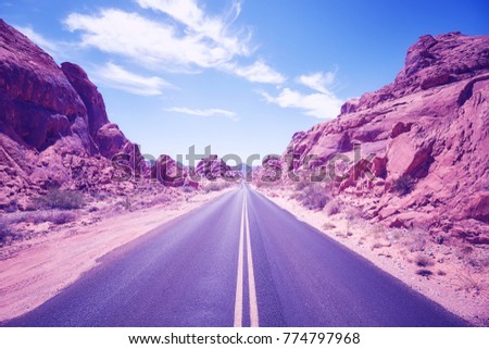 Color toned desert canyon road, travel adventure concept,  Nevada, USA.