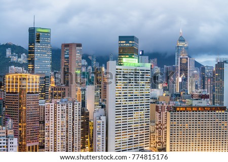 Skyscrapers of Hong Kong at sunset on a cloudy day.
