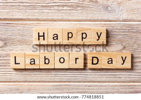 Happy Labor Day word written on wood block. Happy Labor Day text on table, concept.
