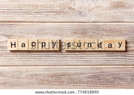 Happy sunday word written on wood block. Happy sunday text on table, concept.