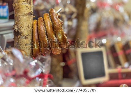 Traditional baked pretzels, hang on the market stall on a stand. On a writable sign you can leave a text. Concept: markets, festivals, food