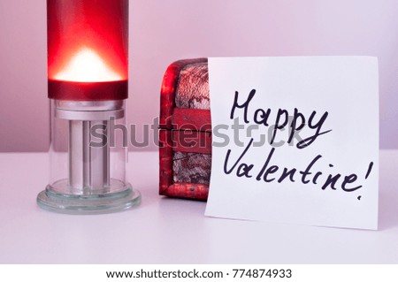 inscription of happy valentine on the background of candles, close- up