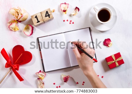 Hand writing on notebook with sweet heart and I love You message on smartphone and laptop on sweet pink Bokeh background for Happy Valentine Day Concept.