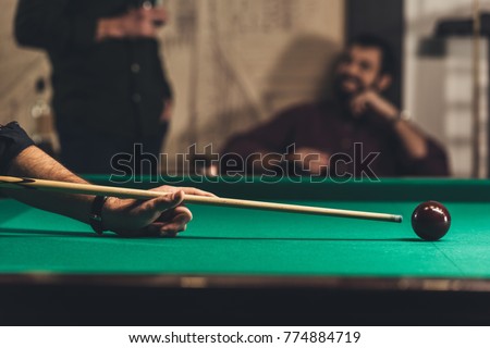 cropped image of successful man playing in pool at bar with friend Royalty-Free Stock Photo #774884719