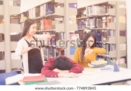 Young tired students rest in University library