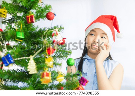 Girl decorates Christmas tree for new year celebration