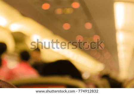 Blurred atmosphere in the cabin of flight attendance and passenger. Background picture in warm tone.