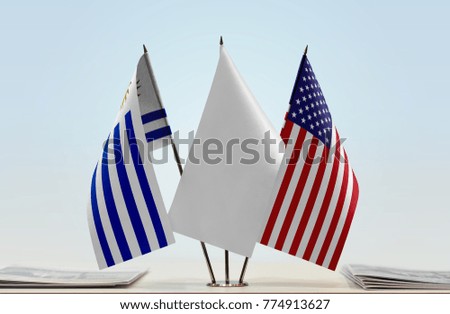 Flags of Uruguay and USA with a white flag in the middle