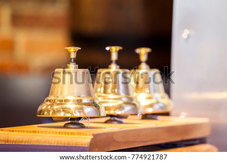 Three decorative golden bells in a row