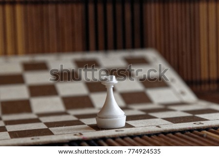 Wooden Chess Board and steel chess pieces, isolated on board