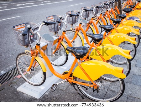 rental yellow bicycle in a row near the street