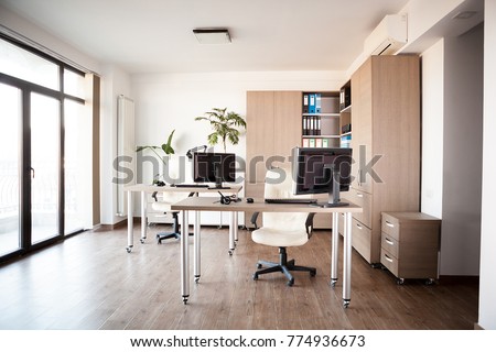 Large angle view. Interior of an empty modern office with an empty desk. Business and workplace. Clean interior of a corporate company Royalty-Free Stock Photo #774936673