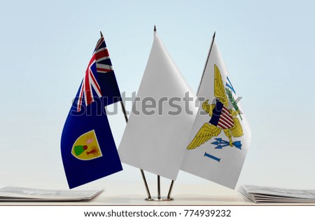 Flags of Turks and Caicos Islands and U.S. Virgin Islands with a white flag in the middle