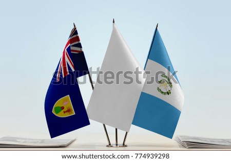Flags of Turks and Caicos Islands and Guatemala with a white flag in the middle