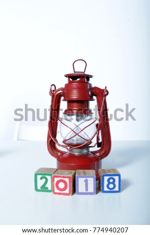 Colorful Wood block 2018 with vintage classic light lantern isolated white background New year concept