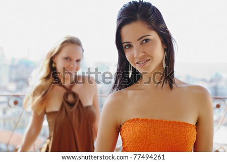 young caucasian female couple looking at camera and smiling. Horizontal shape, waist up, front view