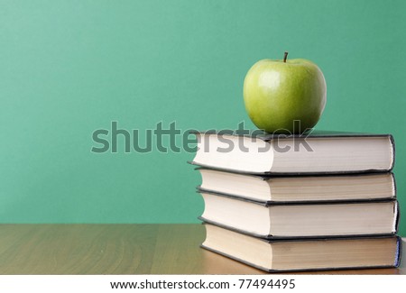 an apple over books