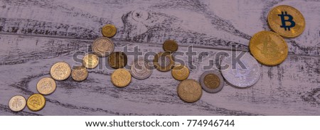 silver and gold bitcoins and Silver Litecoin on wooden background