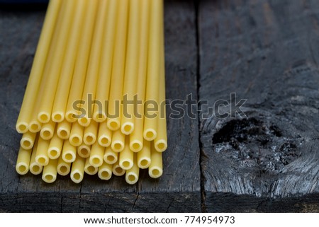 Macaroni pasta on dark rustic wood.