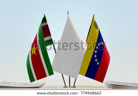 Flags of Suriname and Venezuela with a white flag in the middle