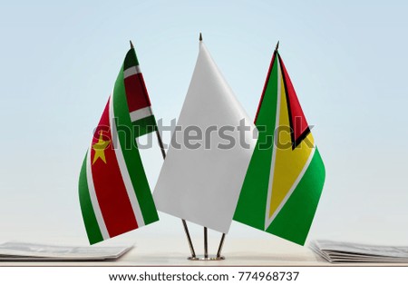 Flags of Suriname and Guyana with a white flag in the middle