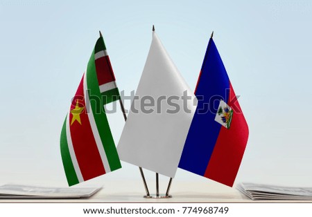 Flags of Suriname and Haiti with a white flag in the middle