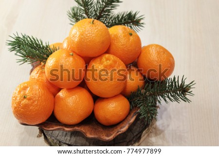 Mandarins with branches of a Christmas tree. Selective focus. Top view.