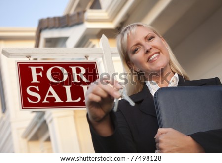 Female Real Estate Agent with Keys in Front of Sign and Beautiful House.