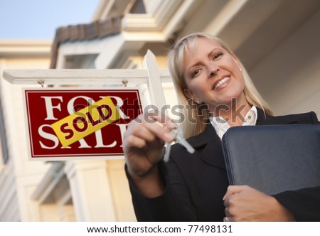Female Real Estate Agent with Keys in Front of Sold Sign and Beautiful House.