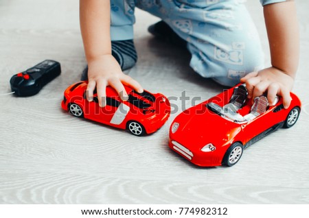 child play red toy cars next to the control panel close-up