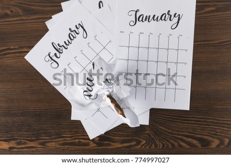 top view of teared paper calendar on wooden tabletop