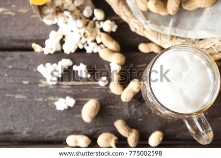 Glass  of  beer with popcorn on wooden table. Top view