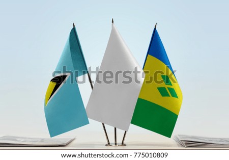 Flags of Saint Lucia and Saint Vincent and the Grenadines with a white flag in the middle