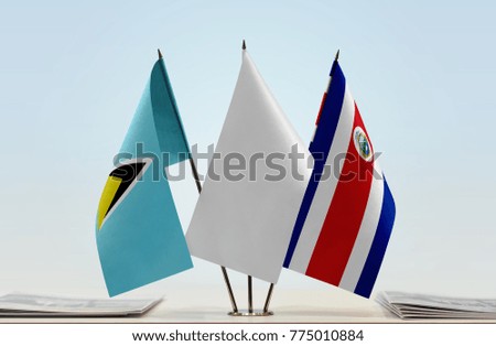 Flags of Saint Lucia and Costa Rica with a white flag in the middle