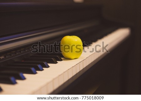 Apple on the classic electrical piano keyboard