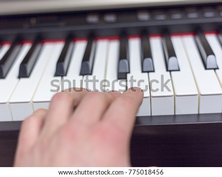 Playing on classic electrical piano keyboard