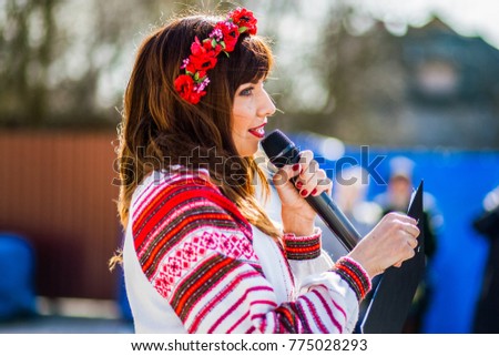 Girl with a microphone speaks to viewers Royalty-Free Stock Photo #775028293